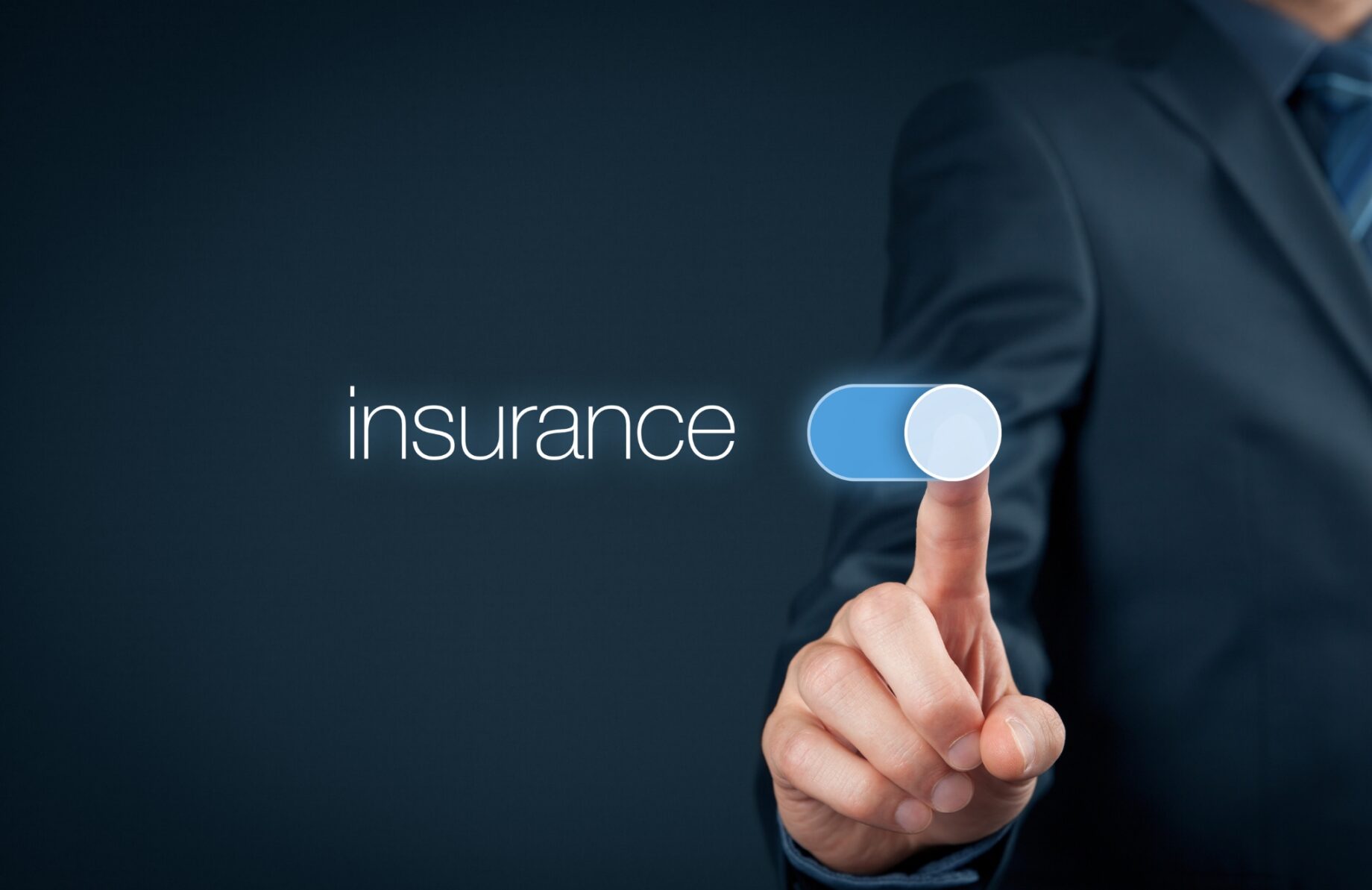 A person switching 'on' a holographic toggle labeled 'Insurance'.